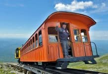 A brakeman waves from the Mt. Washington Cog Railway in Bretton Woods, New Hampshire.