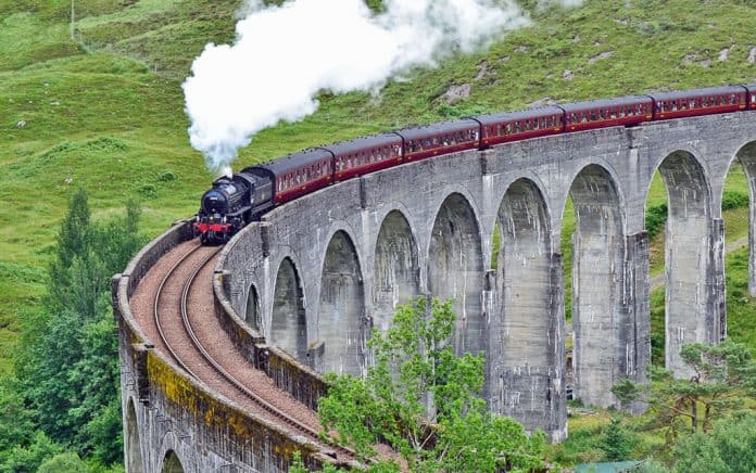 The Jacobite Steam Train crosses the famous Glenfinnan Viaduct in Lochaber, Scotland.