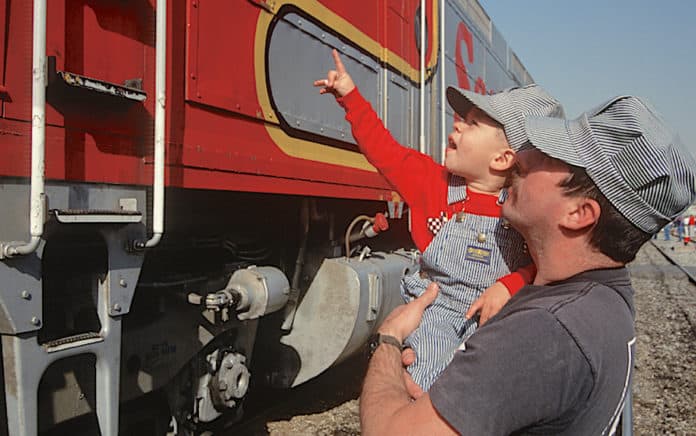 Dad and son by historic train
