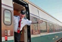 Amtrak Cascades conductor extends a warm welcome aboard.
