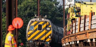 Amtrak Keystone Express train passes track replacement operation in Bristol, Pennsylvania.