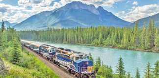The Rocky Mountaineer heads west along the Bow River in Alberta, Canada.