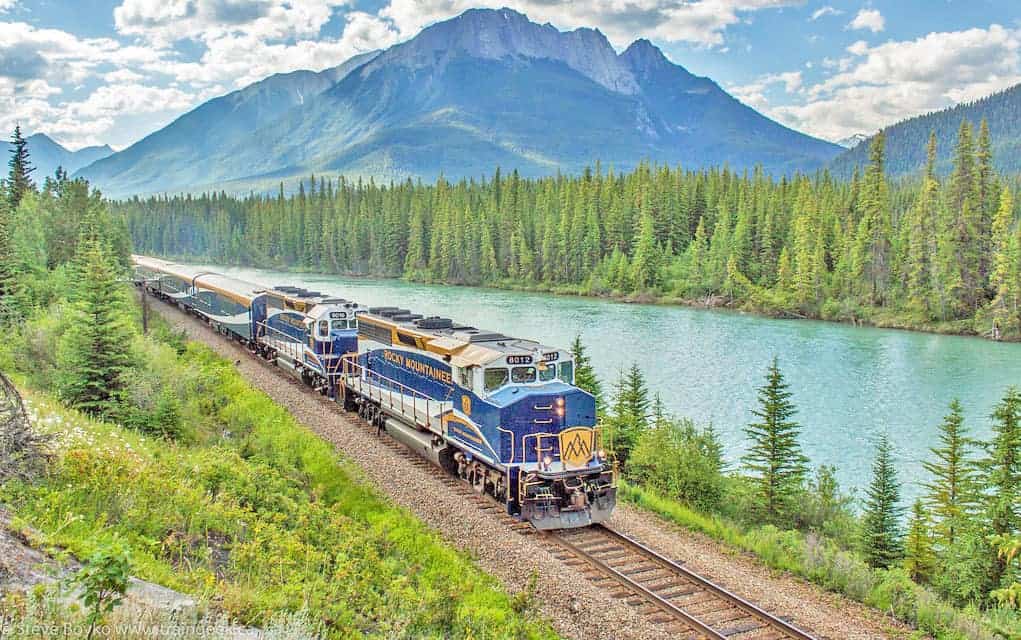 The Rocky Mountaineer heads west along the Bow River in Alberta, Canada.