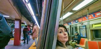 Woman riding on the New York City subway.