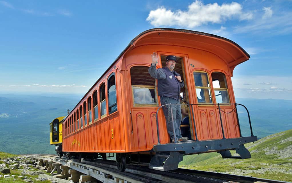 A brakeman waves from the Mt. Washington Cog Railway in Bretton Woods, New Hampshire.