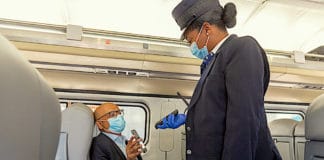 Masked Amtrak passenger and conductor