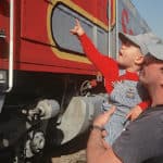 father-son-looking-historic-train-1021×640